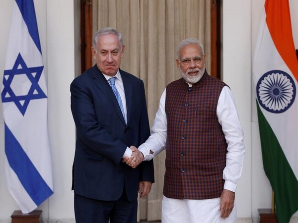 Israeli Prime Minister Netanyahu shakes hands with his Indian counterpart Modi during a photo opportunity ahead of their meeting at Hyderabad House in New Delhi