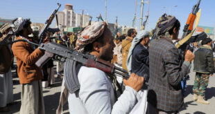 Newly recruited Houthi fighters hold up firearms during a ceremony at the end of their training in Sanaa