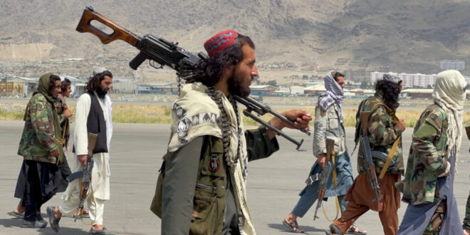 Taliban forces patrol at a runway a day after U.S troops withdrawal from Hamid Karzai International Airport in Kabul