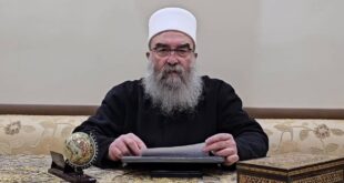 Hikmat al Hijri reading a speech in 2024