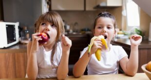 baby sisters having healthy snack 23 2148281920